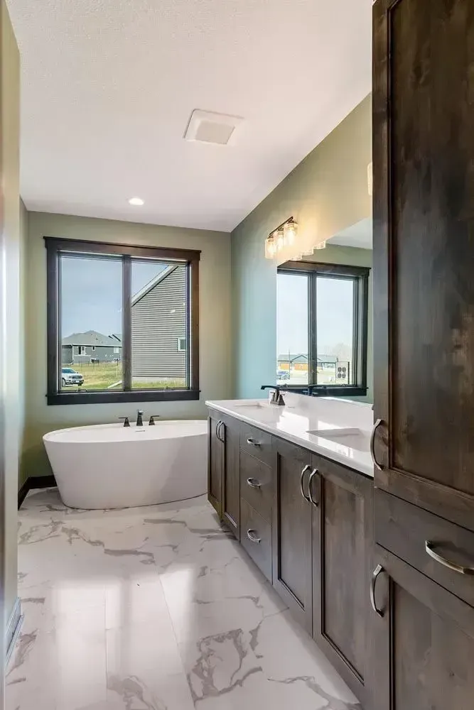 a bathroom with a large tub and two sinks