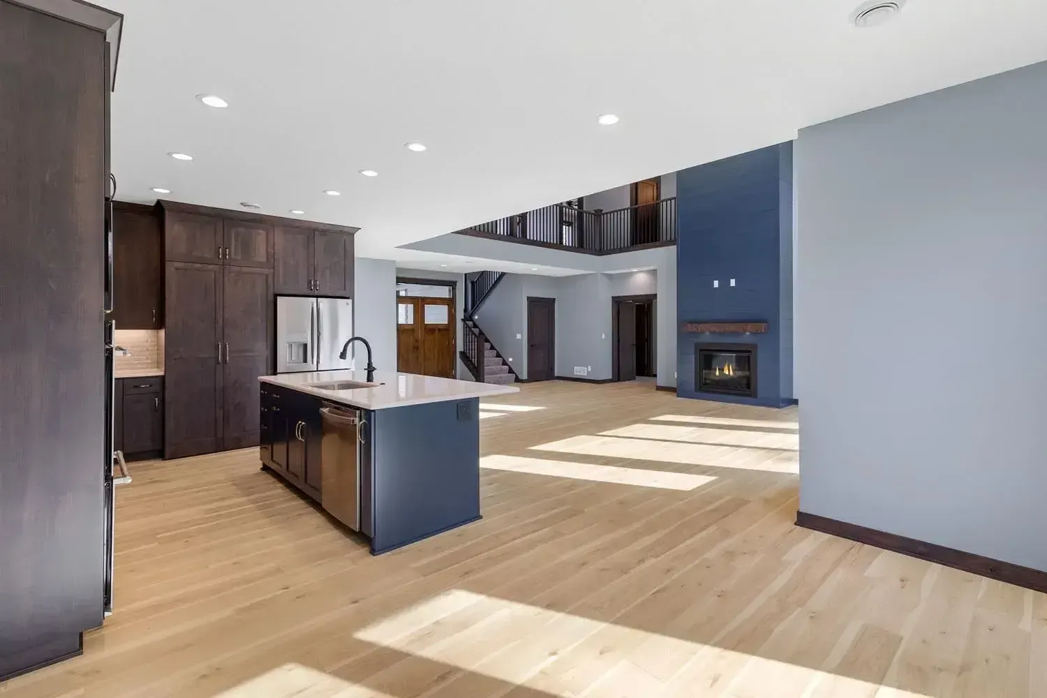 a kitchen with a blue island and stainless steel appliances