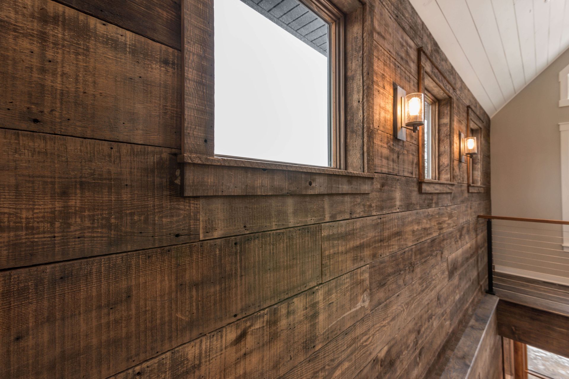 A wooden wall with a lot of windows in a house