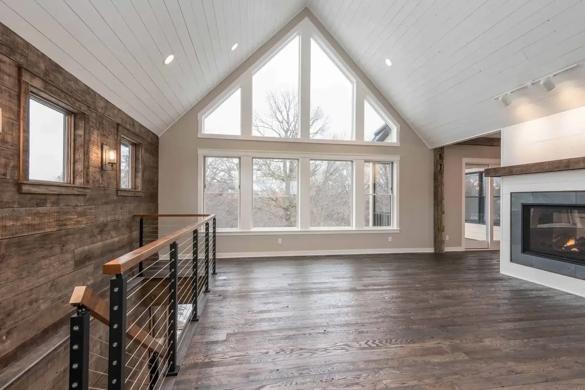 A wooden staircase with a metal railing in a house