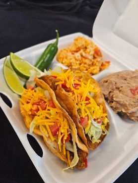 Chicken and vegetable wrap on a brown surface.