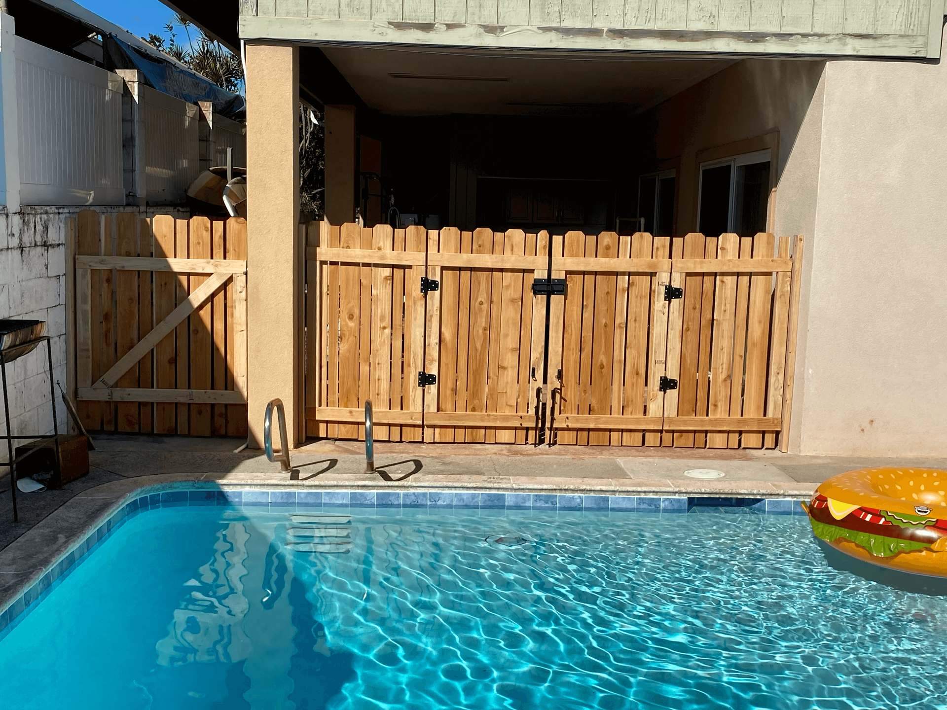a series of 3 images: 1 of a new fence installed next to a pool, 1 of a hardscape design with gravel, and the third of a custom paver design in manoa