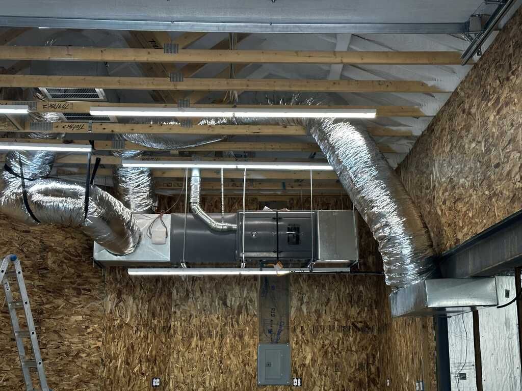 A room with a lot of pipes hanging from the ceiling.