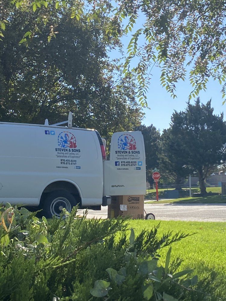 Two white vans are parked next to each other on the side of the road.