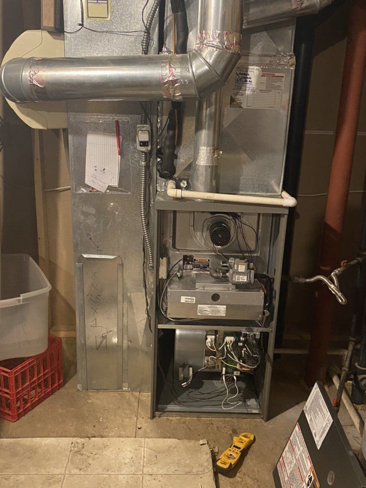 The inside of a heating and cooling system in a basement.