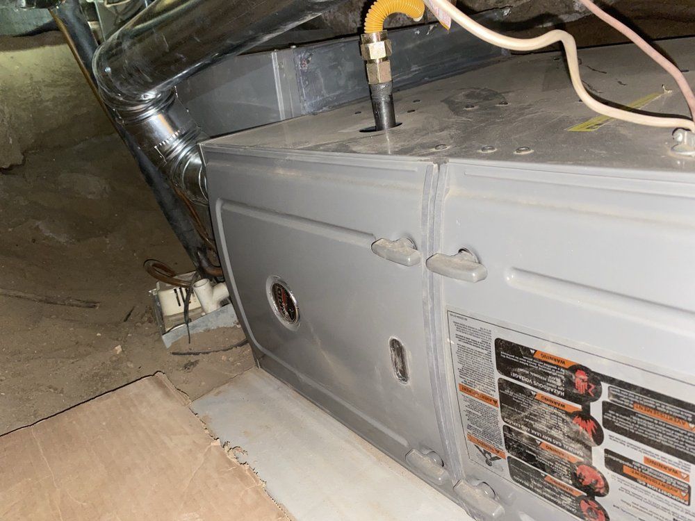 A gray box with a yellow hose attached to it