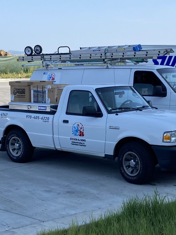 Two white trucks are parked next to each other in a parking lot.