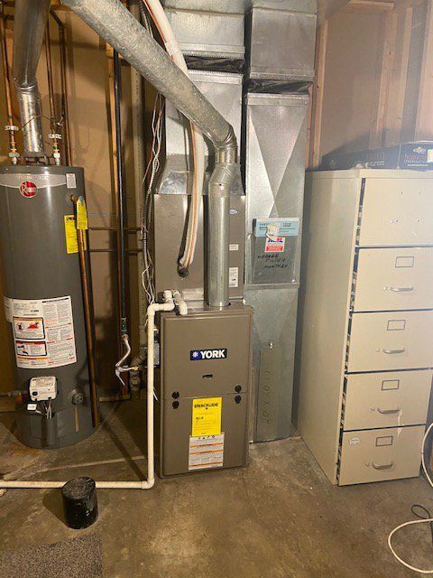 There is a water heater and a furnace in the basement.