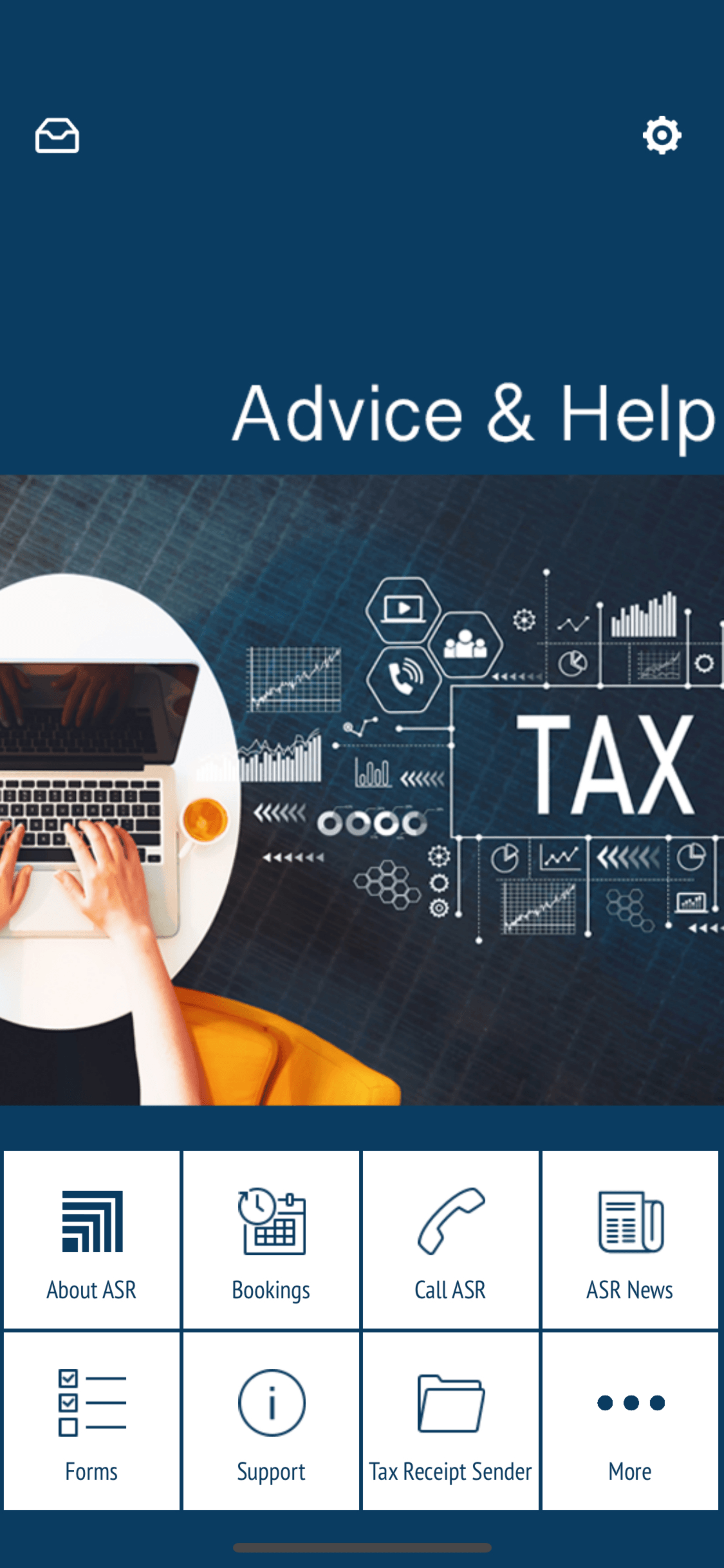 A person is typing on a laptop computer in front of a blackboard.