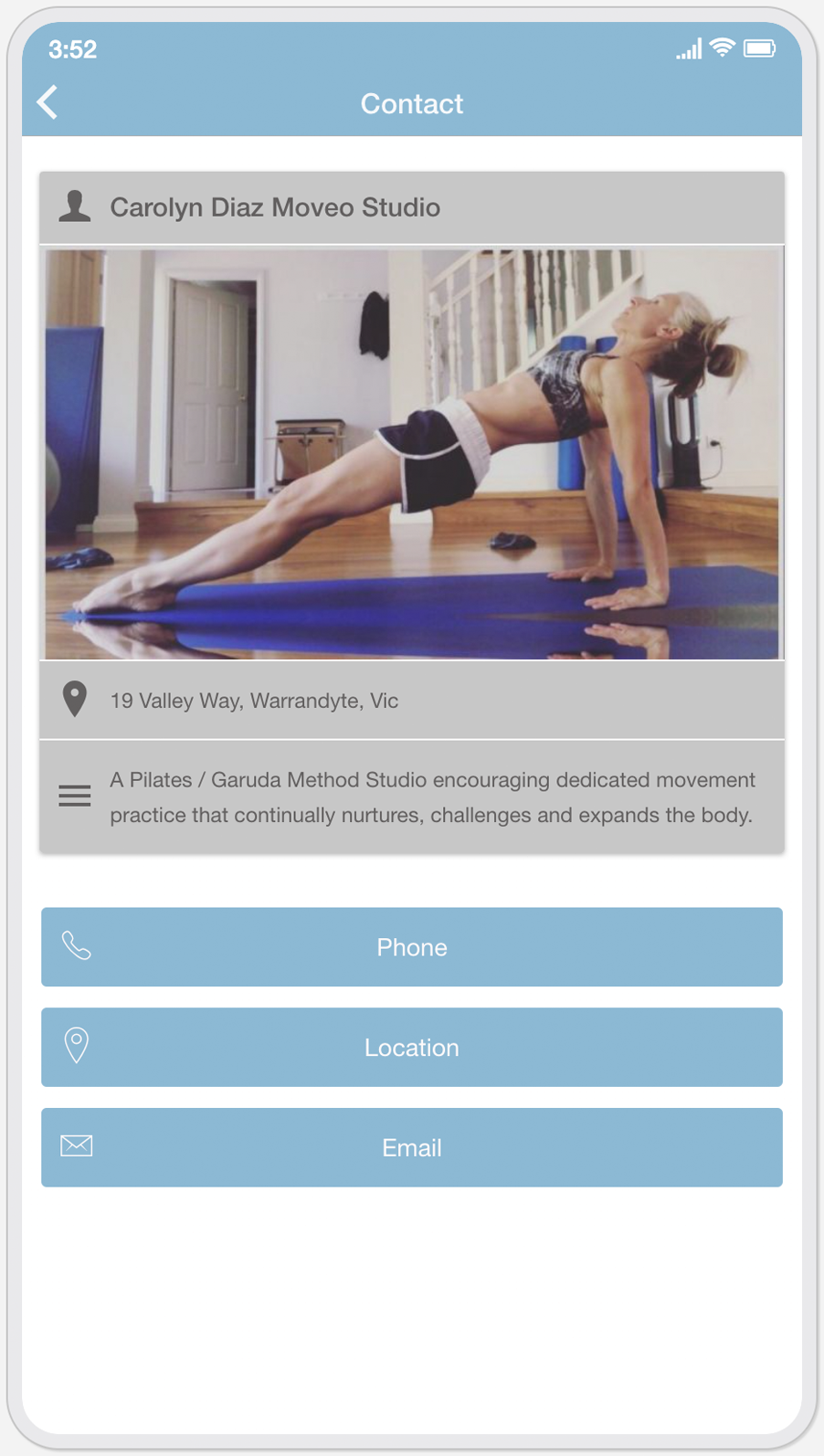 A woman is doing a yoga pose on a yoga mat on a cell phone.