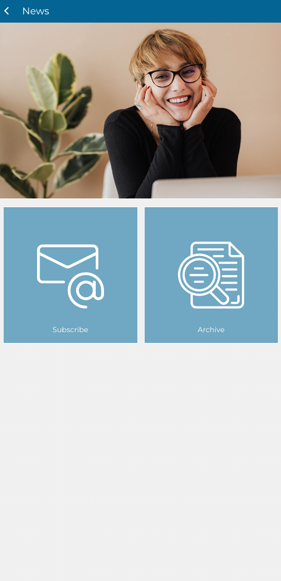 A woman is sitting at a desk talking on a cell phone.