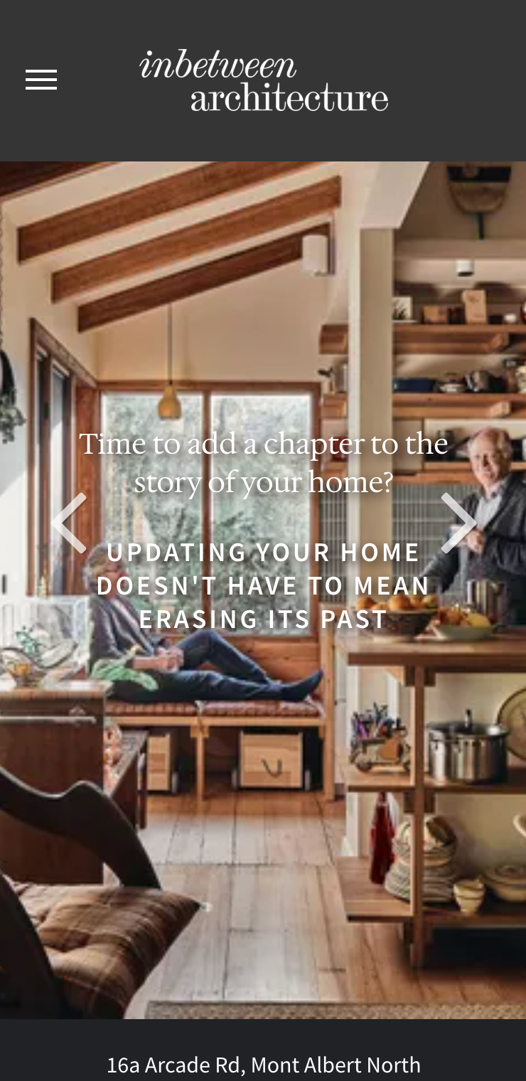 A man is laying on a bench in a living room. inbetween architecture website