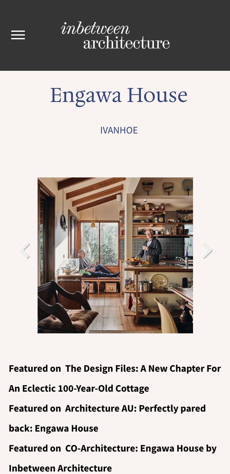 A man is sitting in a chair in a living room in a house. inbetween architecture website