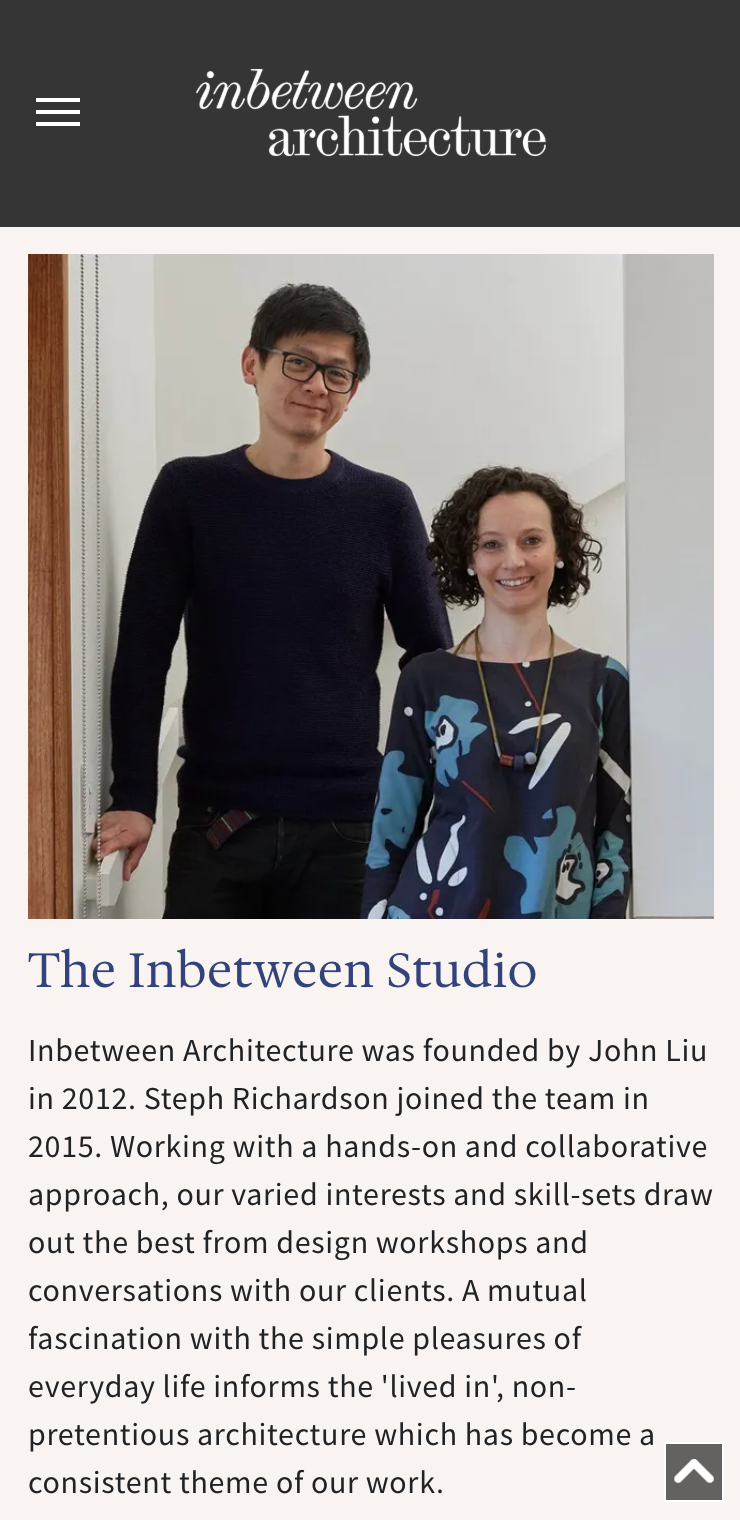 A man and a woman are standing next to each other in a room. inbetween architecture website