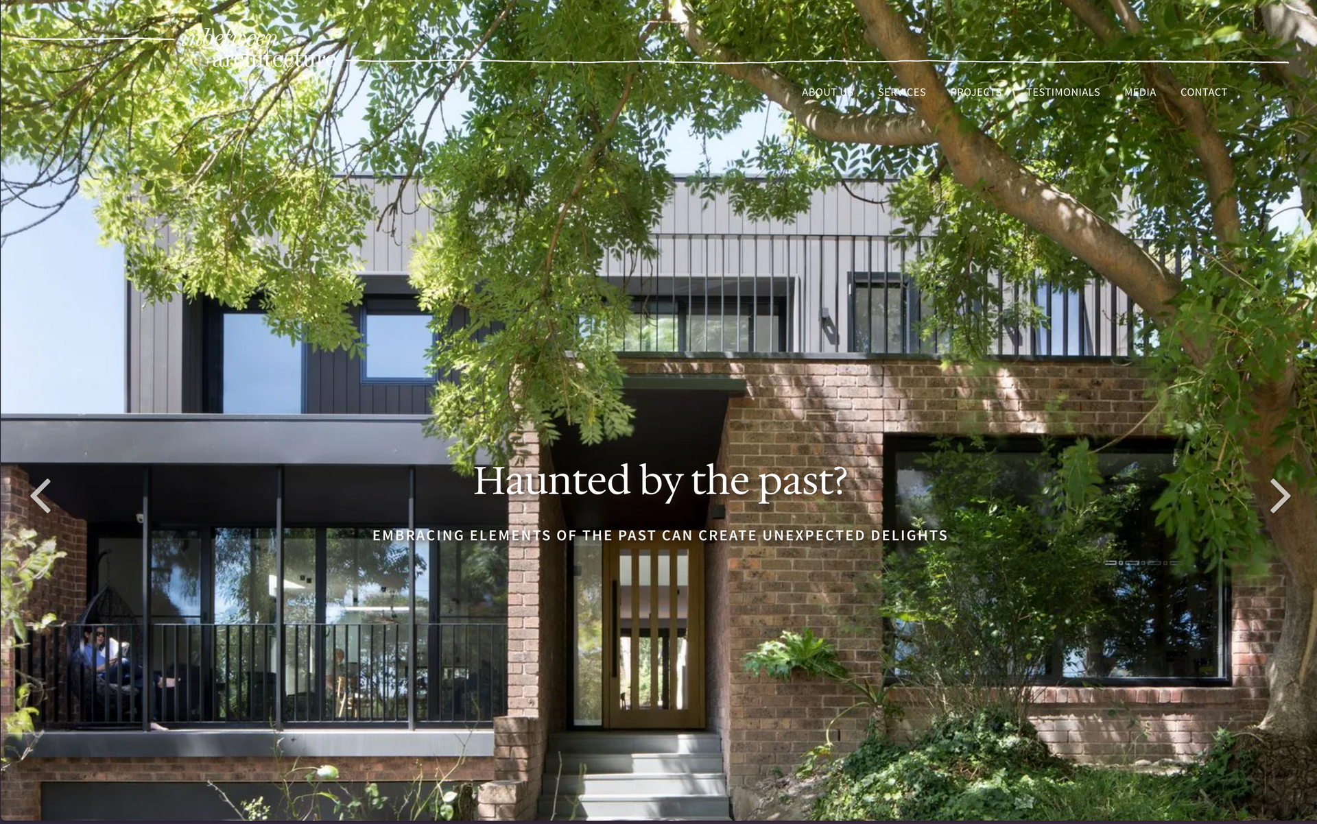 A brick house with a balcony is haunted by the past. inbetween architecture website