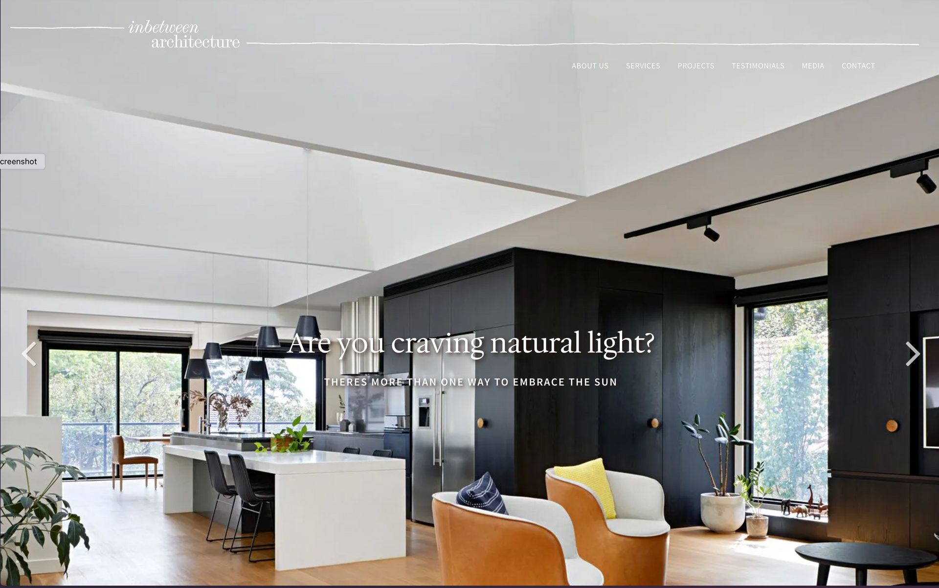A screenshot of a website showing a living room and kitchen. inbetween architecture website