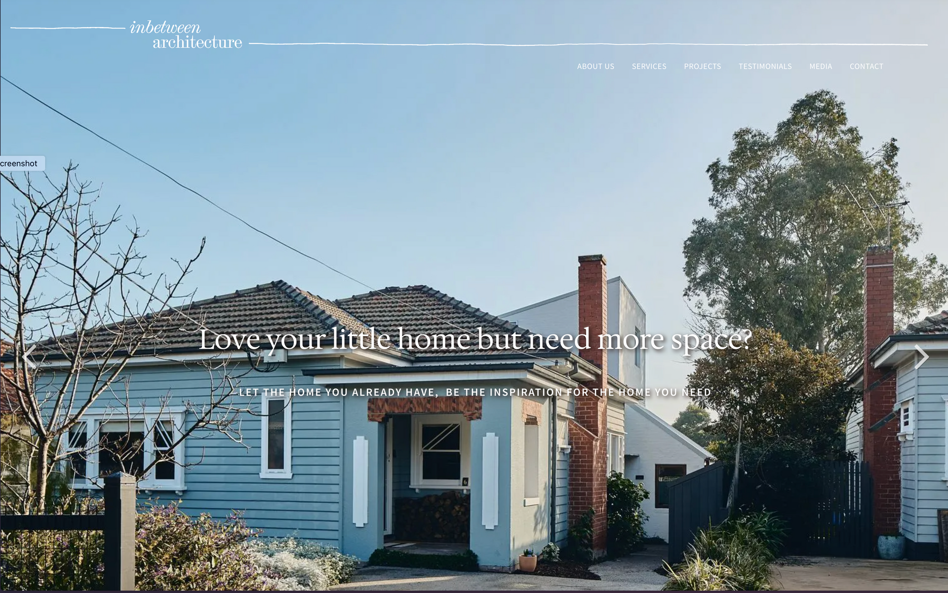 A blue house with a red chimney is on a website. inbetween architecture website
