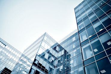 A building with a lot of windows and a blue sky in the background