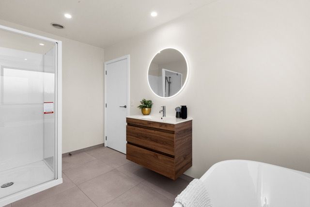 A bathroom with a sink , mirror and bathtub