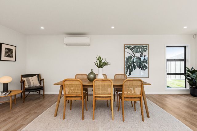 A dining room with a table and chairs in it