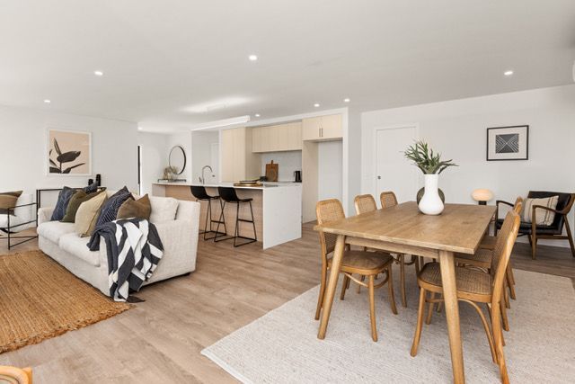 A living room with a dining table and chairs and a couch.
