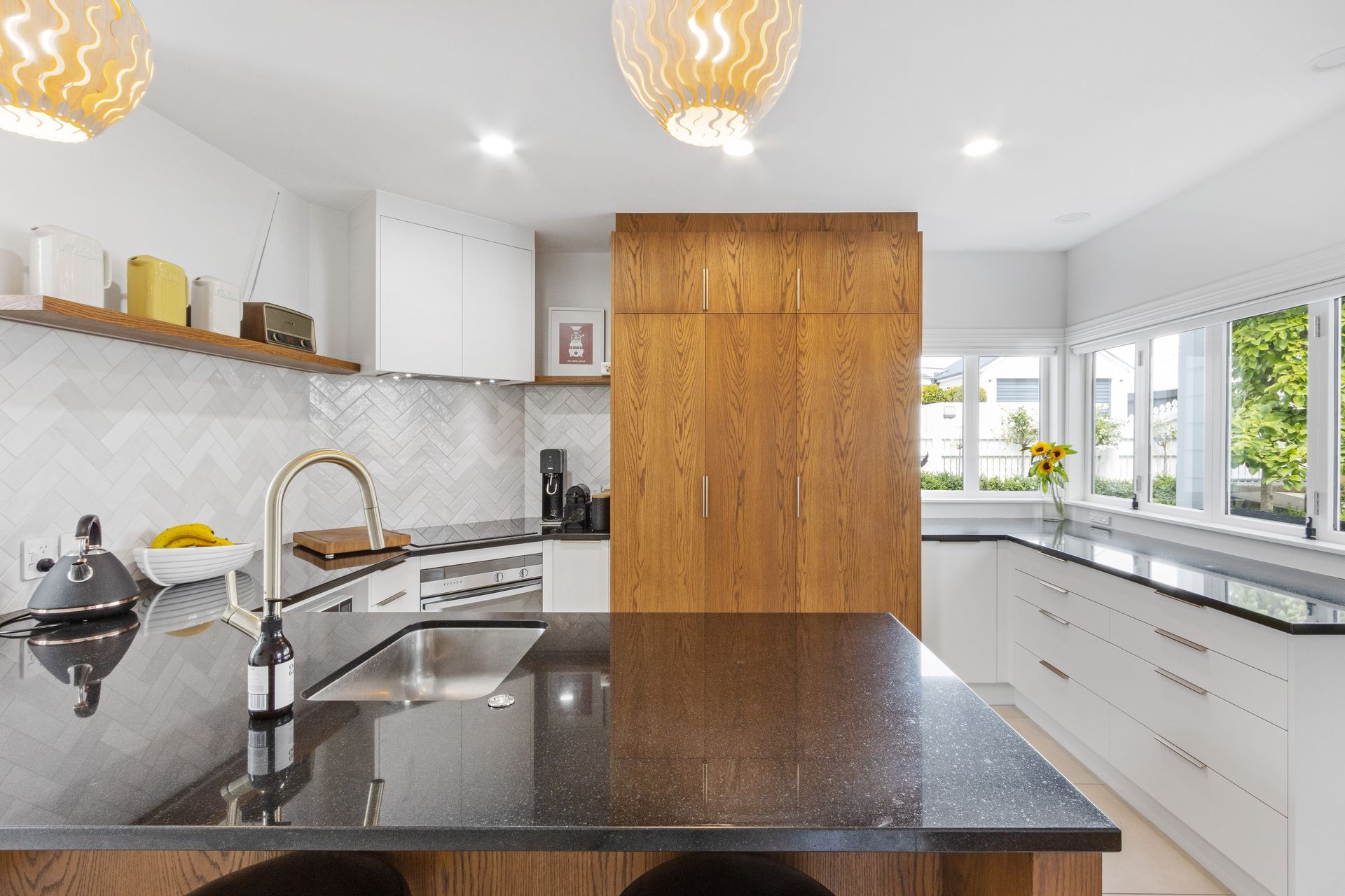 A kitchen with a large island and a sink.