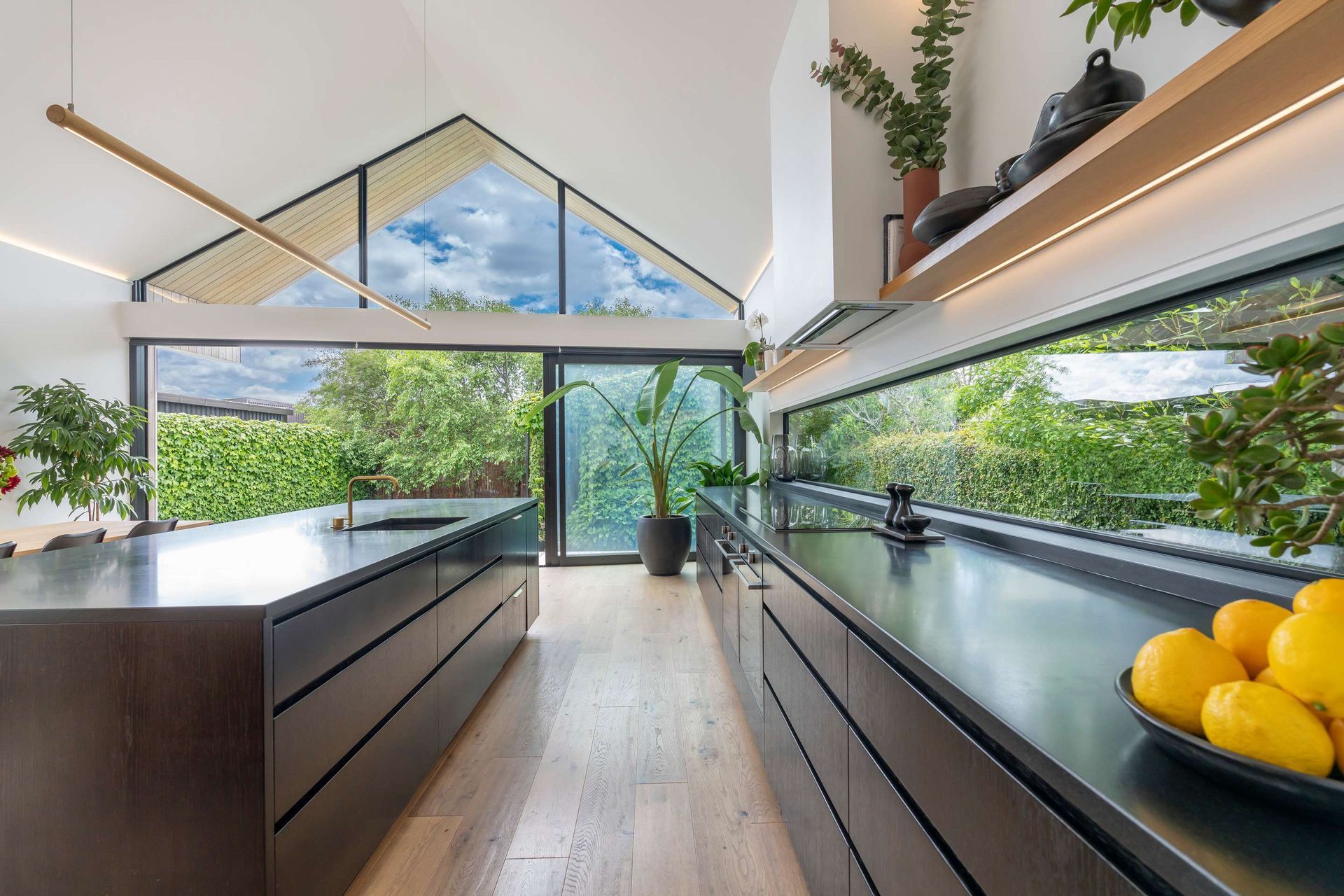A kitchen with a large island and a bowl of lemons on the counter.