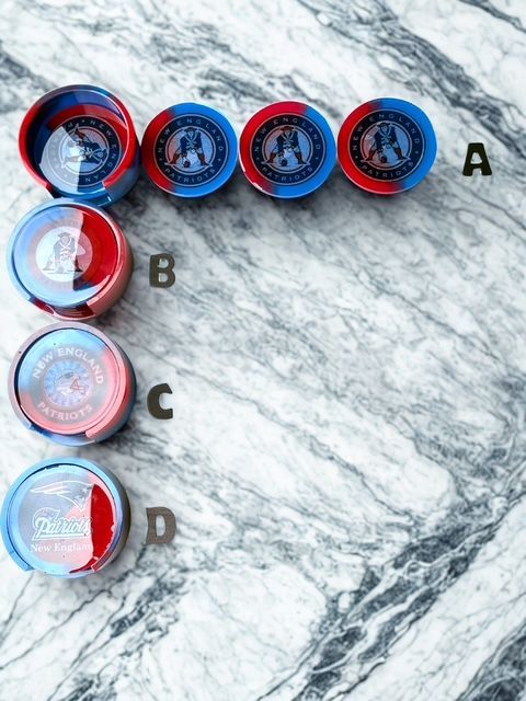 A marble surface with a row of red and blue containers with letters a b c and d on them