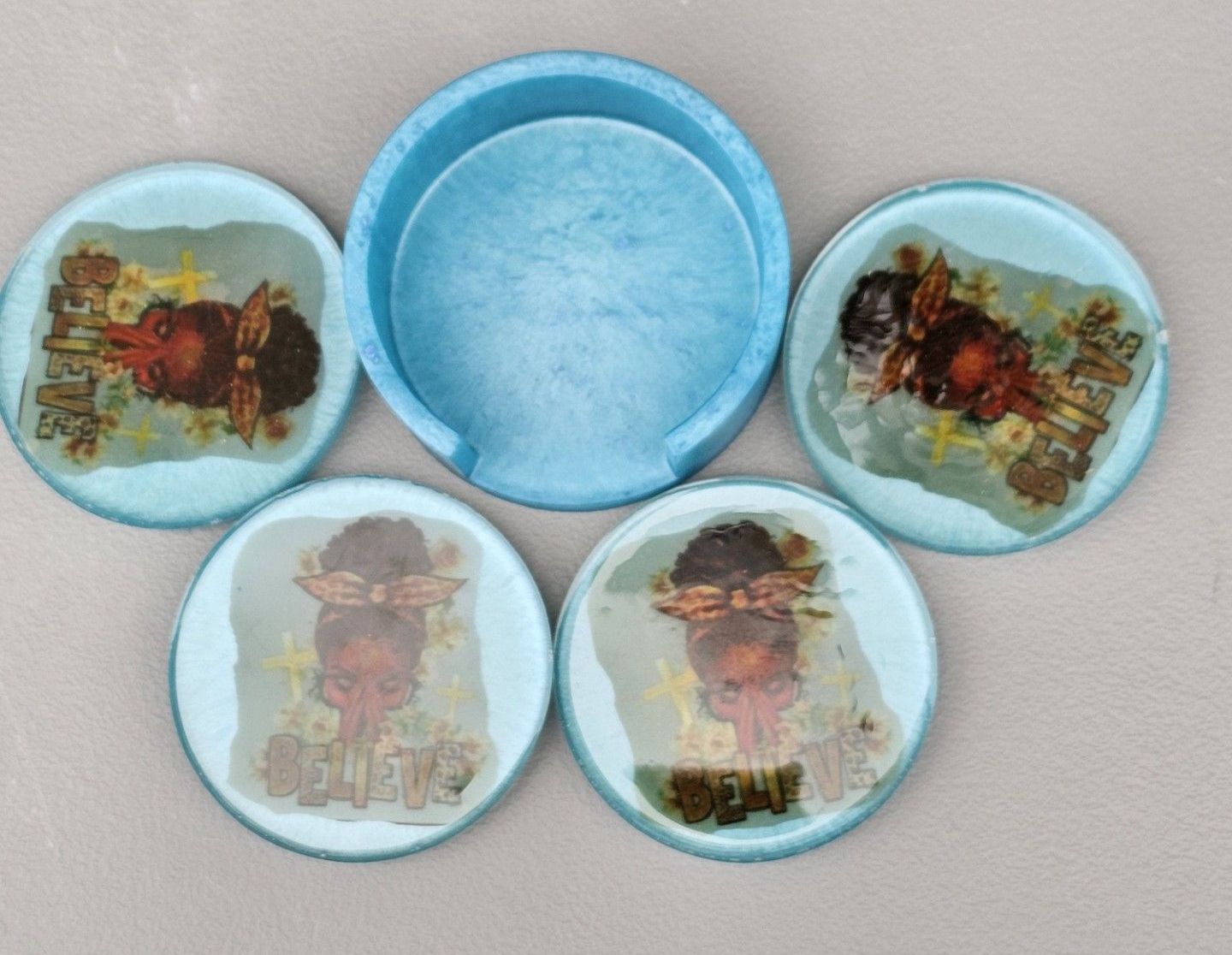 A set of four coasters with jesus on them