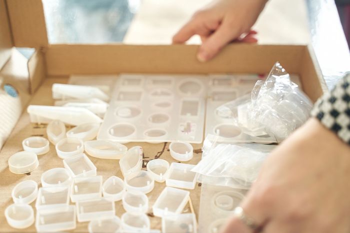 A person is looking at a box of silicone molds.