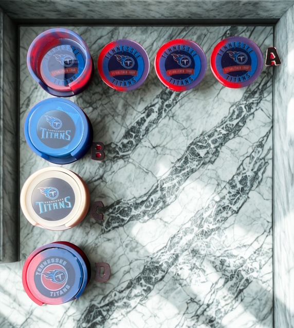Tennessee Titans coasters on a marble surface, red, blue, and white colors, arranged in a row.