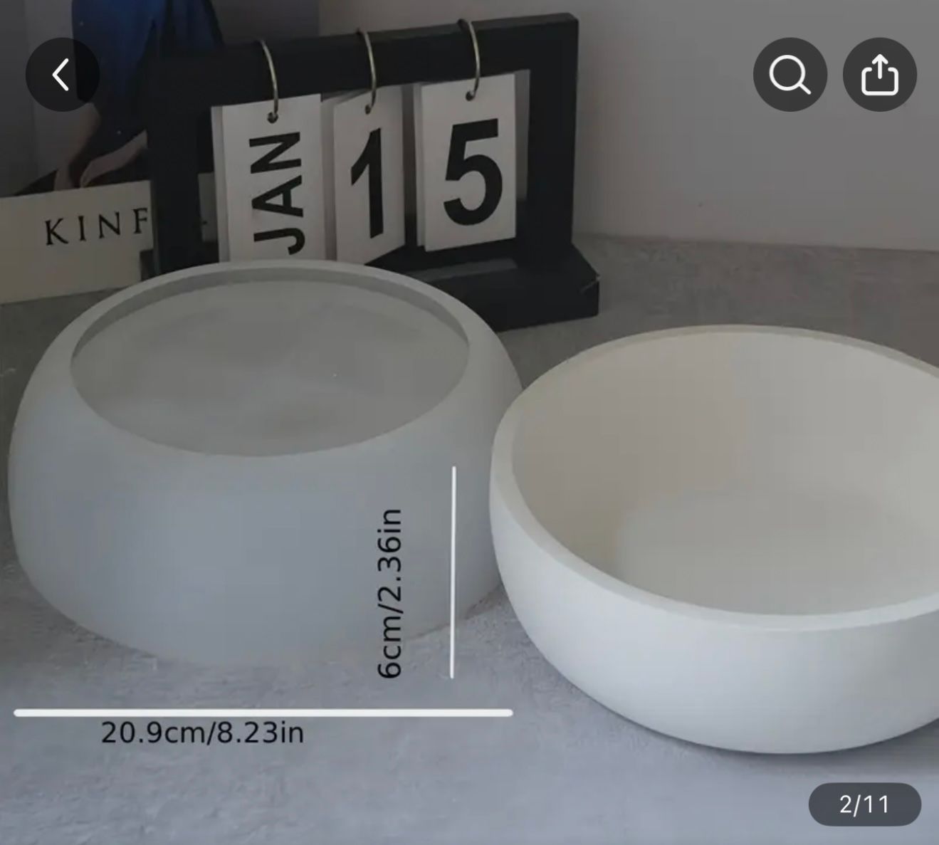 Two white, round bowls; one frosted, the other plain. A desk calendar behind them reads