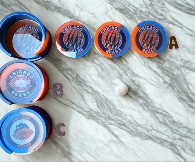Chicago Bears-themed resin coasters with holder on marble surface; color scheme blue, orange, and white.