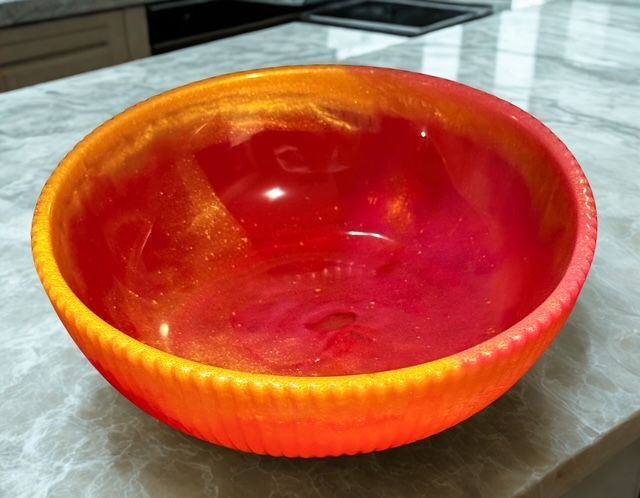 A red and yellow bowl is sitting on a counter