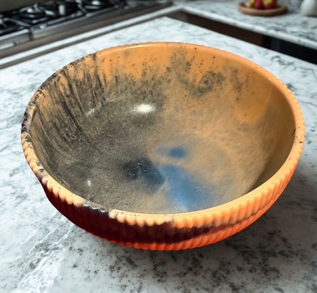A dirty bowl sits on a marble counter top
