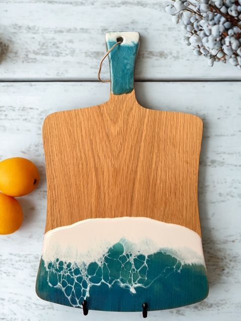 A wooden cutting board with a blue and white design on it