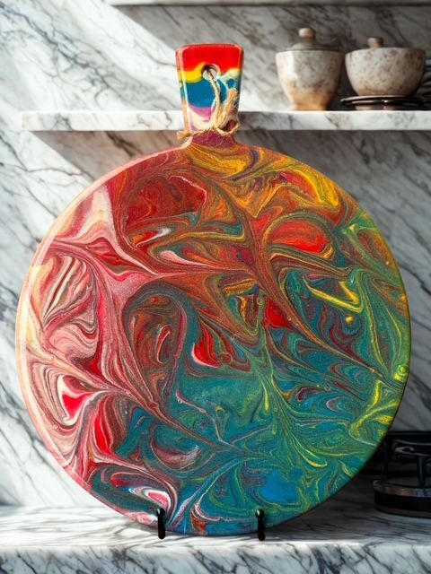 A marble cutting board with a colorful design on it