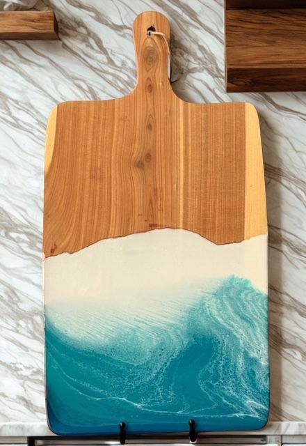 A wooden cutting board with a picture of the ocean on it.