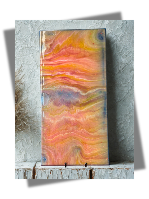 A painting is sitting on a table next to a wall.