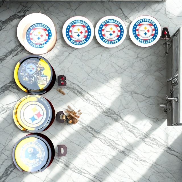 Pittsburgh Steelers plates on a marble countertop with sunlight, and a faucet fixture.