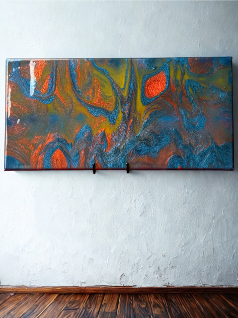 A large colorful painting is hanging on a white wall.