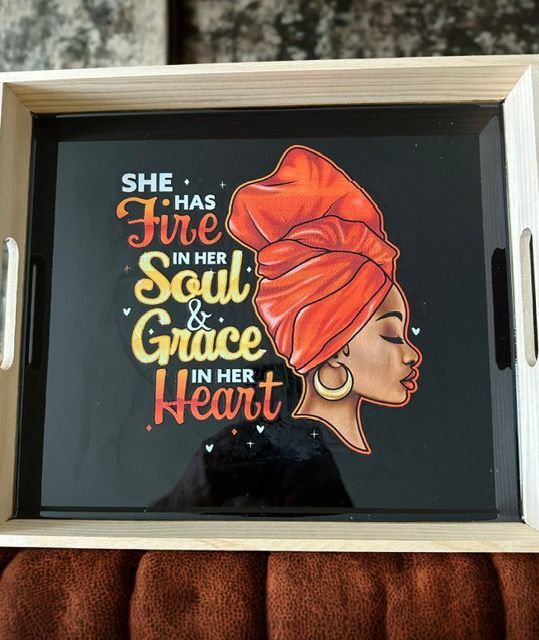 A tray with a picture of a woman and the words she has fire in her soul and grace in her heart