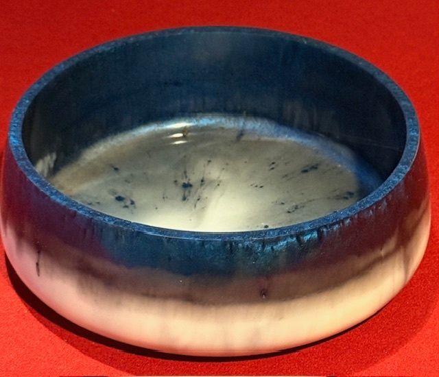 A blue and white bowl on a red surface