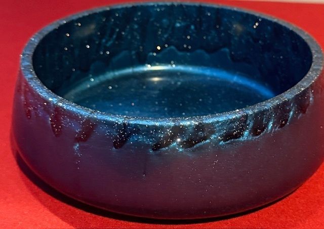A blue bowl is sitting on a red surface
