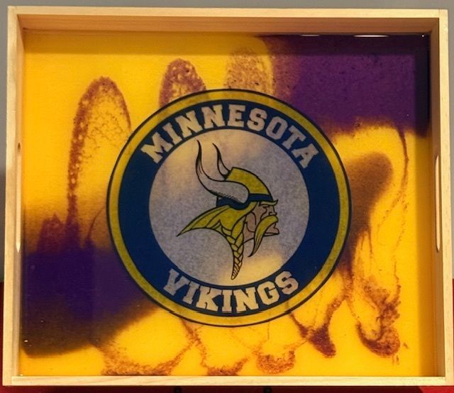 A minnesota vikings logo on a yellow and purple background