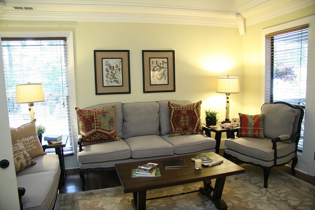 A living room with a couch , chairs and a coffee table