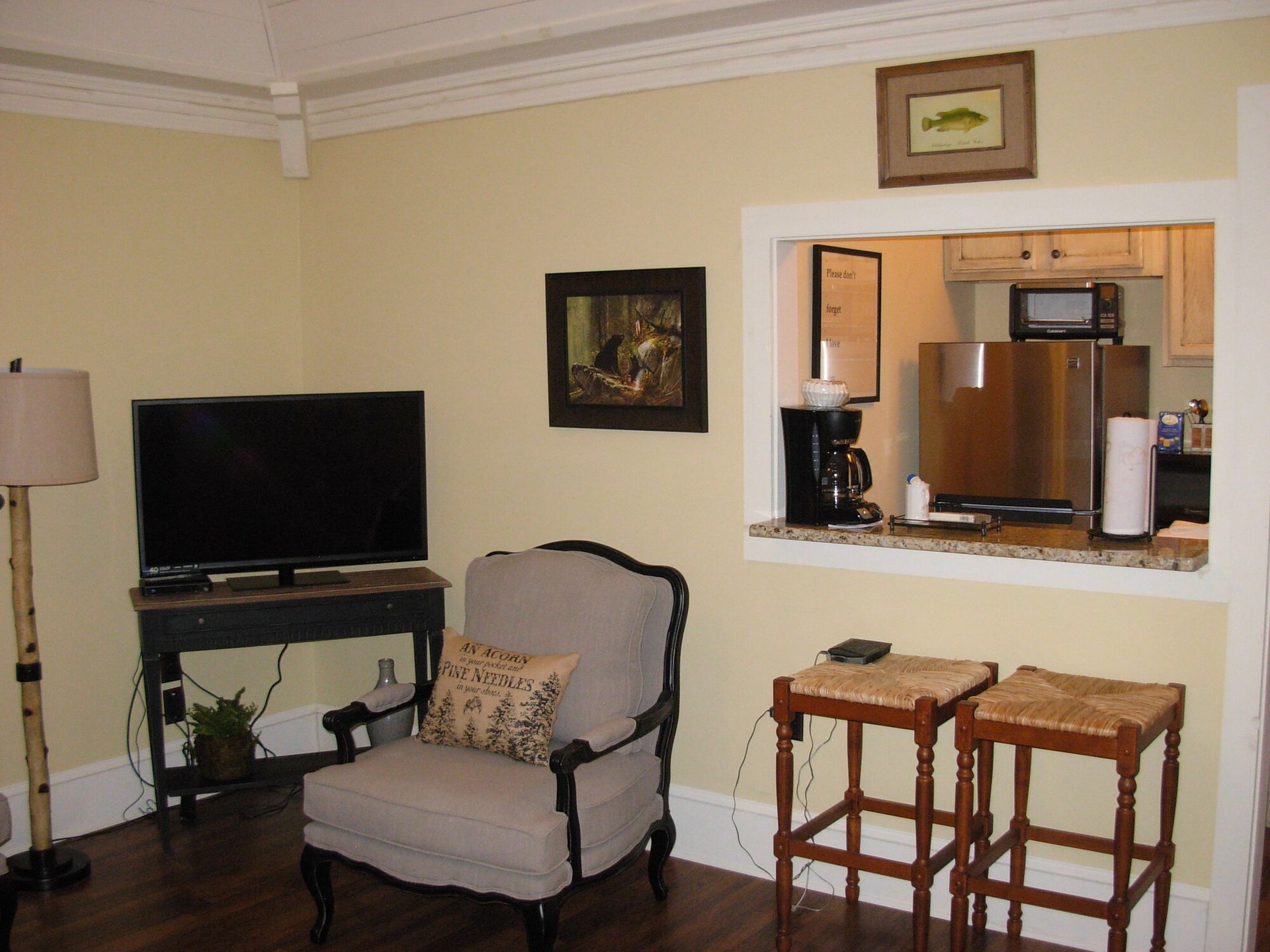 A living room with a chair and a flat screen tv