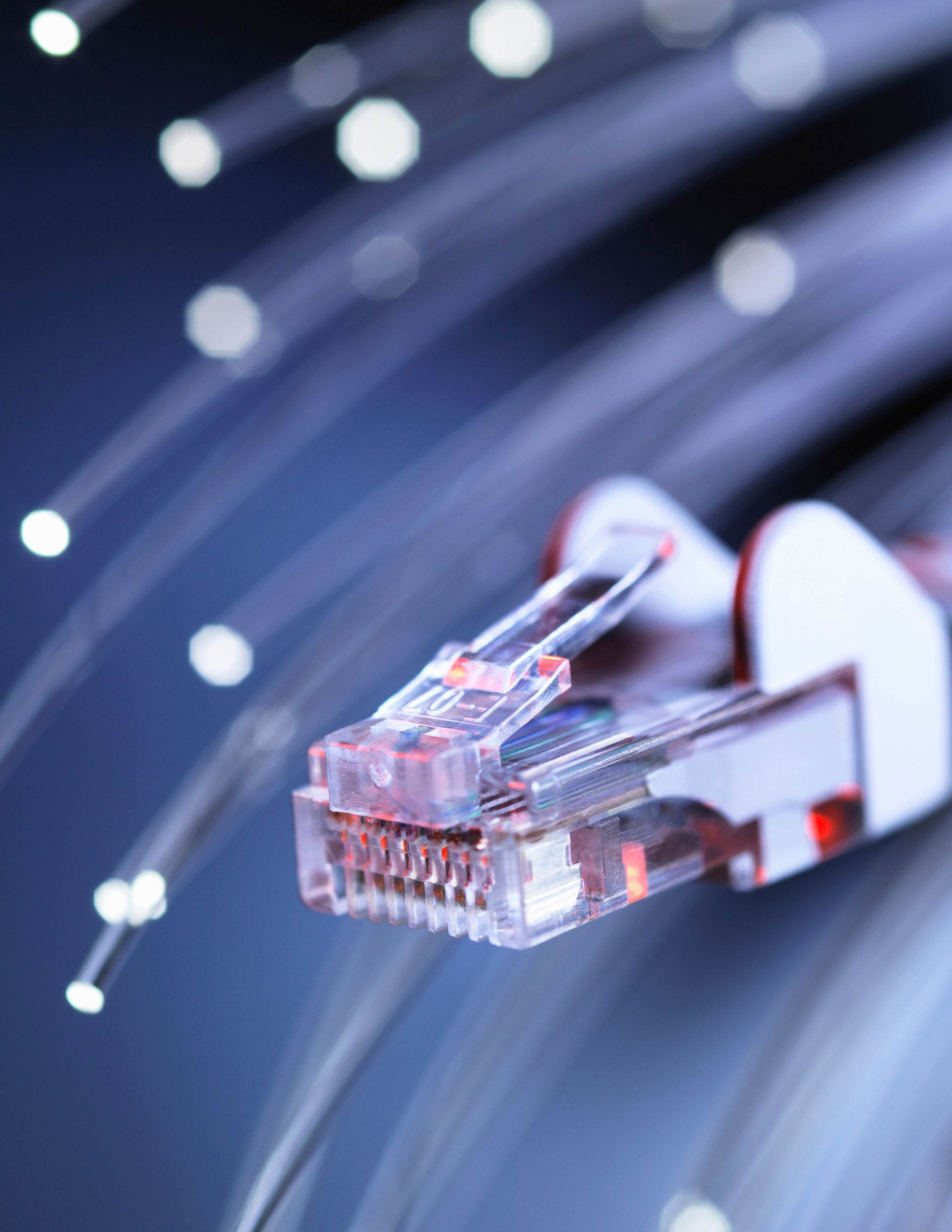 A close up of an ethernet cable with fiber optics in the background