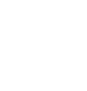 A young boy is wearing a high-visibility yellow vest and a white hard hat while standing in a construction site.