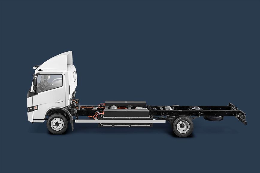 A white cab-chassis truck against a solid dark blue background.